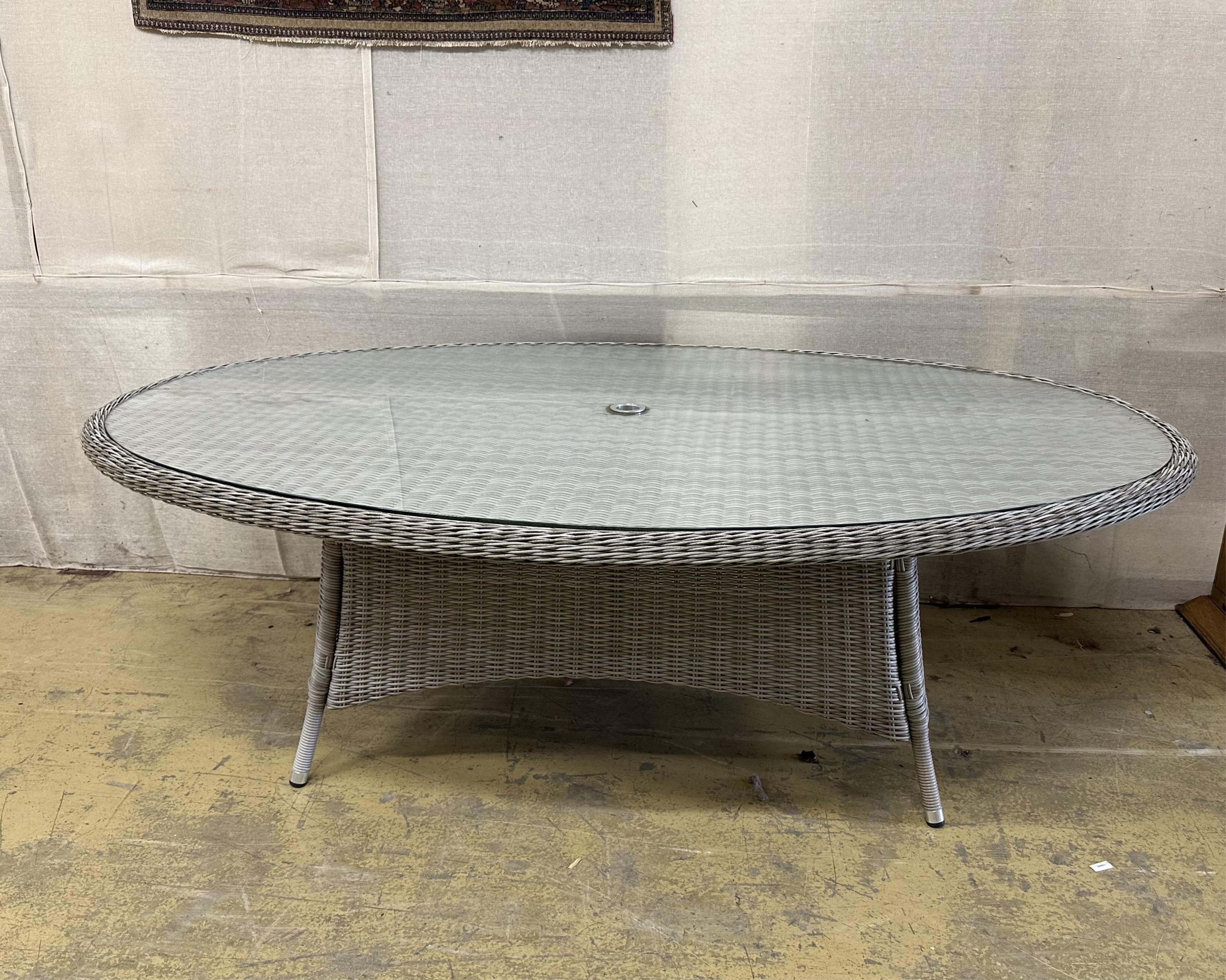 A Bramblecrest oval all weather rattan garden table, width 220cm, depth 145cm, height 73cm. Condition - good